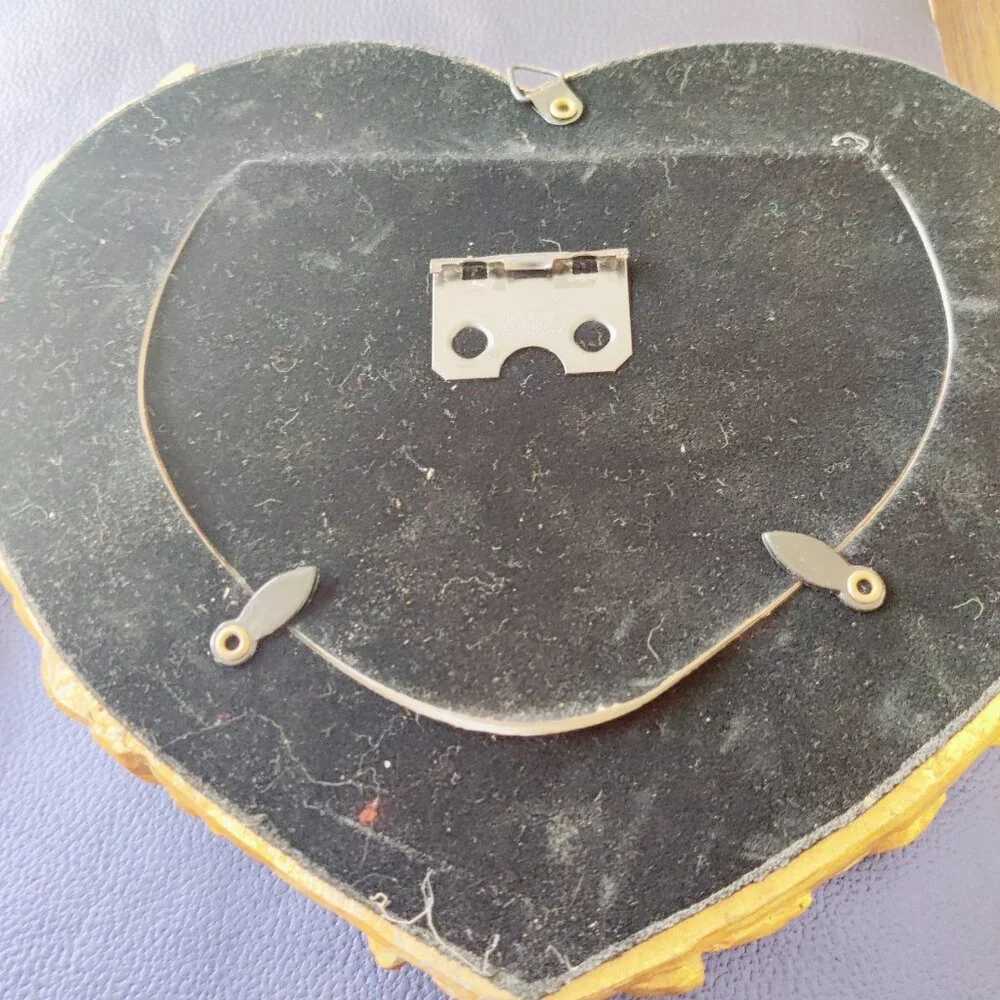 Picture Frames from Nordstroms a heavy gold heart frame with Roses & Leaf Border